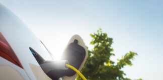 Charging an electric car with power supply cable.