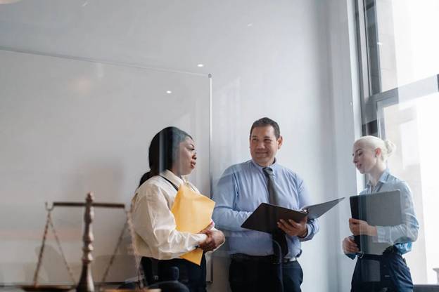 Professional diverse colleagues talking about work in modern office 