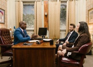 Car accident attorney consulting with a client in a modern office
