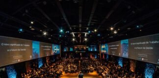 The Fine Print Behind Keynote and Coaching Contracts A speaker on a conference stage in front of a large seated audience